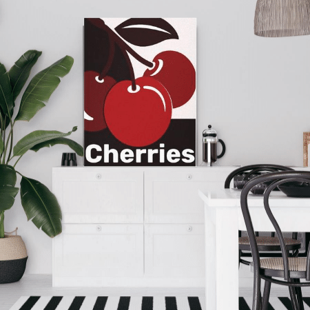 a dining area in black and white showing cherry wall art as a poster print in red hues darkened by black and lightened by white