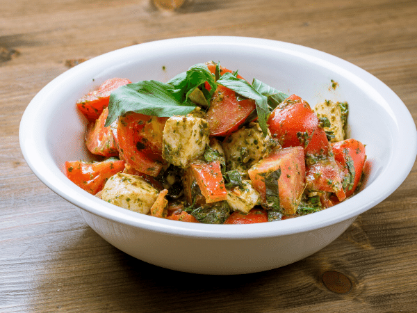 tomato and mozzarella salad mixed in a salad bowl
