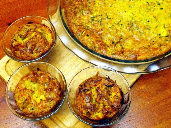 A mixture between an omelette and a cake is a crustless quiche. This one is made with shredded carrots and zucchini with a mild herbal taste which is supported by the use of basil.