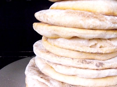 Making this pita bread recipe is simple but it requires patience and a little practise as rolling out dough and placing it in the pan becomes an art. 